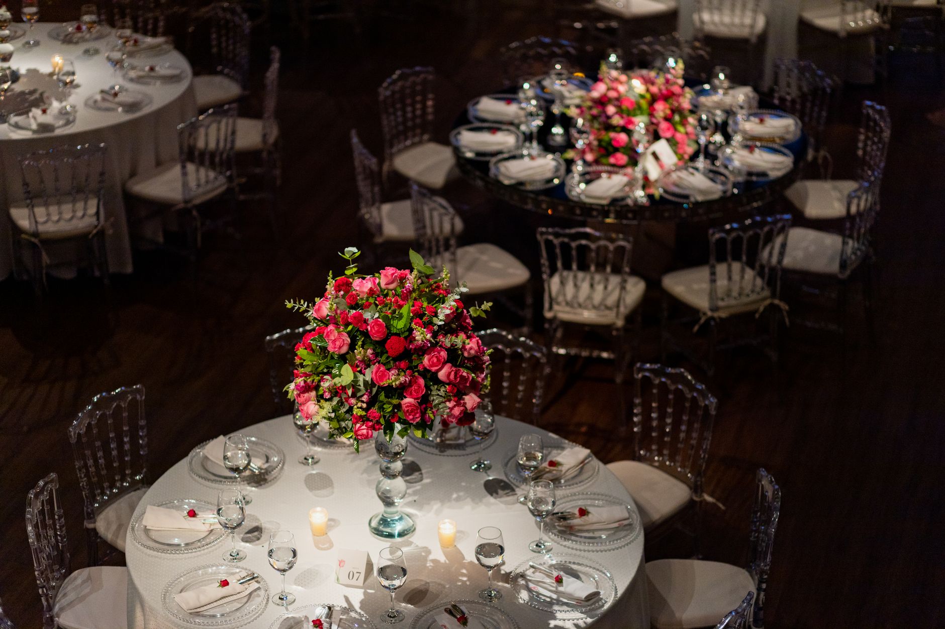 A round reception table dressed with a low floral centrepiece