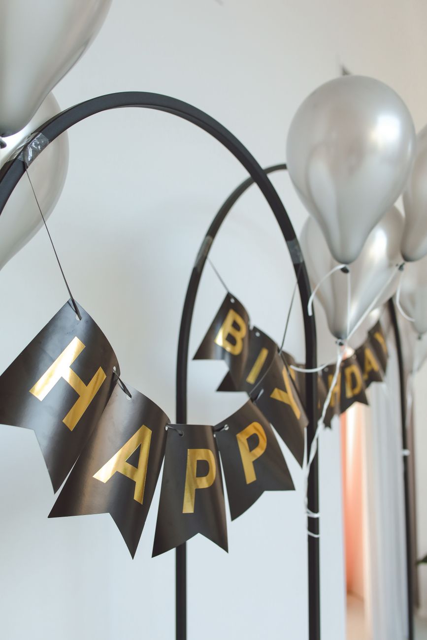 A balloon and floral arch built for a birthday celebration