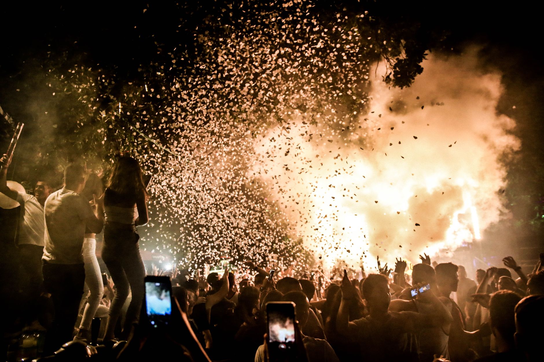 Confetti falling over a dance floor at night