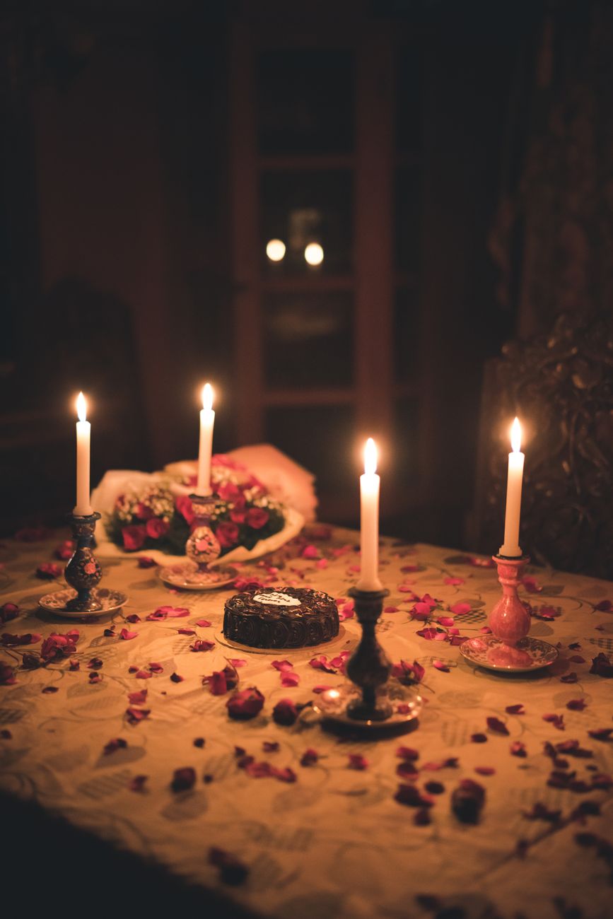 An anniversary dinner lit by taper candles
