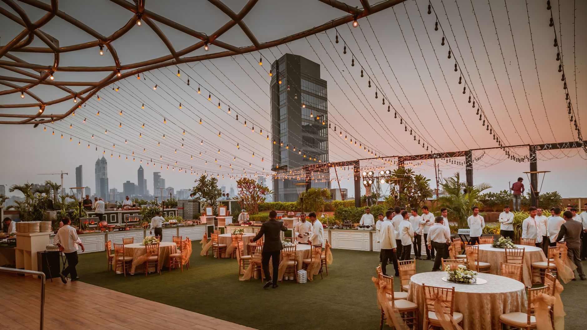 A rooftop evening event under strung lights