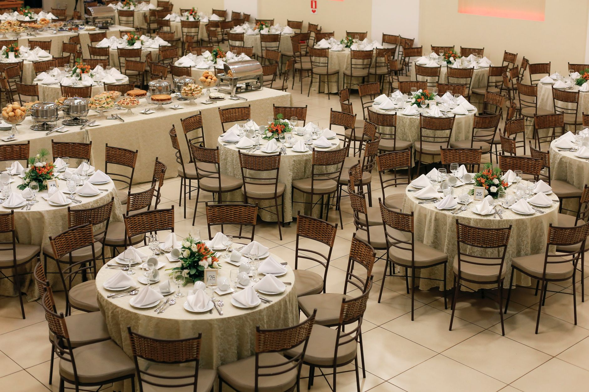 A farm table laid with ivory linen and a runner