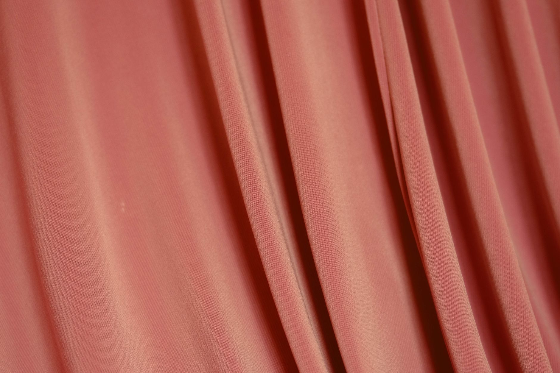 A pleated drapery backdrop behind a stage